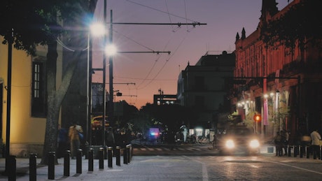 City street with trolleybus at night