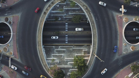 City traffic going around a roundabout from above.