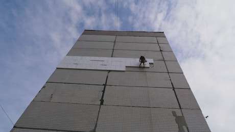 Climber working on a multi story building