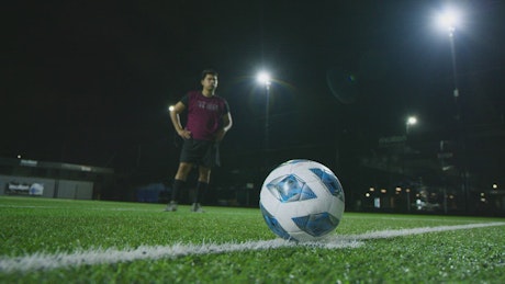 Close shot of a soccer player shooting a penalty.