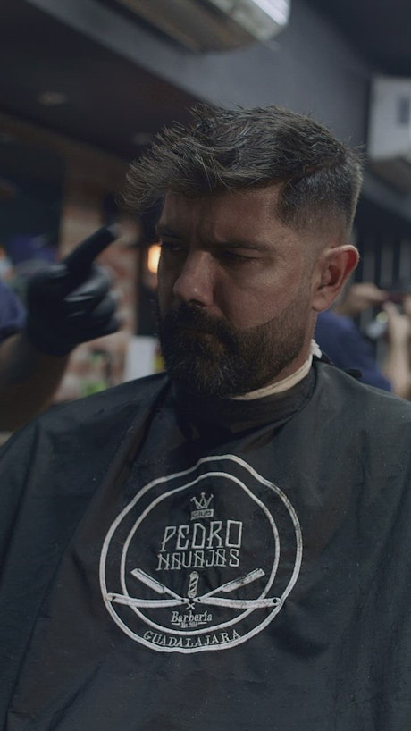 Close up of a man getting a haircut.