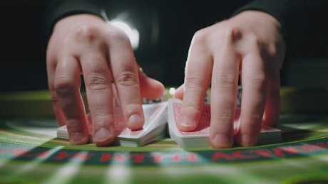 Close up of a man mixing poker cards.