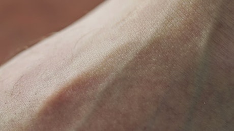 Close up of a pulsating vein under skin.