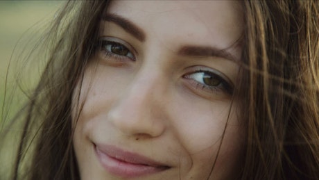 Close up of a smiling woman's face.
