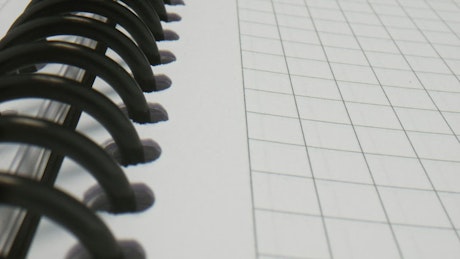 Close up of a spiral notebook spine.
