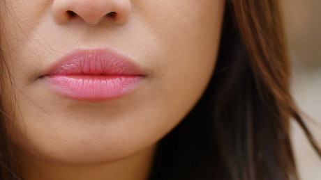 Close up of a woman's lips and nose.