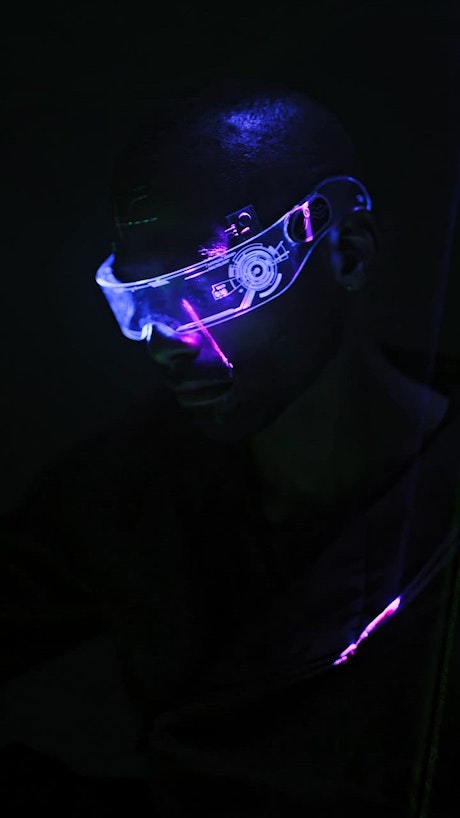 Close up of cyberpunk glasses with neon laser lights.