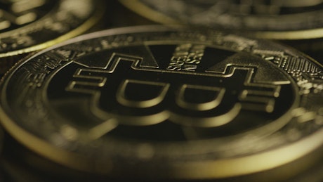 Close up of golden bitcoins in motion.