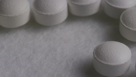 Close up of white pills rotating