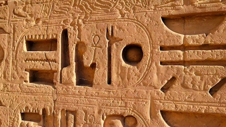 Close up panning shot of ancient hieroglyphics in Egypt.