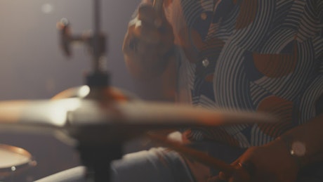 Close up shot of a drummer playing in a studio.