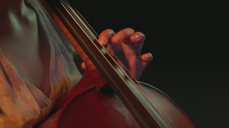 Close up shot of a female cellist playing.