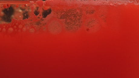 Close-up view of a bubbling red liquid.
