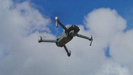 Close-up view of a drone flying outdoors.
