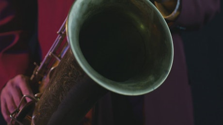 Close view of a saxophonist playing a song.