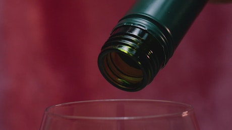 Close view of the mouth of a bottle when pouring wine.