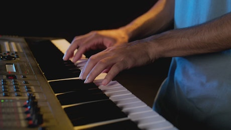 Close view on the hands of a pianist playing.