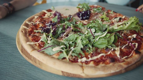 Closeup of vegetarian pizza on wood table.