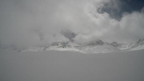Clouds in snowy mountain