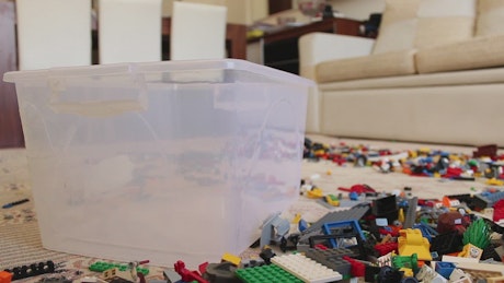Collecting Lego pieces in a plastic box