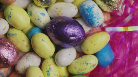 Colorful easter candy eggs rotating.