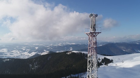 Communications antenna tower in the snowy mountains.