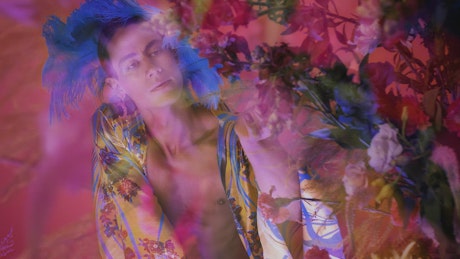 Concept video of an LGBTQ man surrounded by flowers.