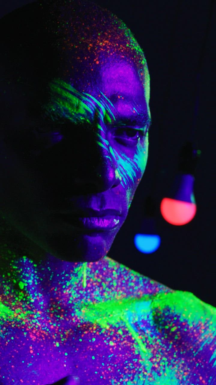 Conceptual video of a man splattered with  live draw super wuhan fluorescent paint