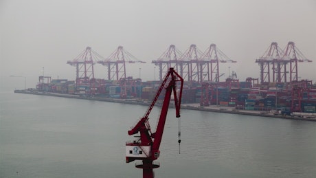 Container terminal with cranes on a foggy day.