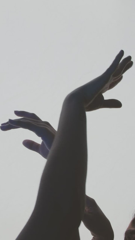 Contemporary dancers hands on a light background.