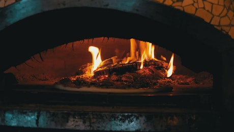 Cooking pizza in a traditional oven.