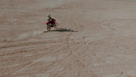 Cool aerial tracking shot of a motorcyclist