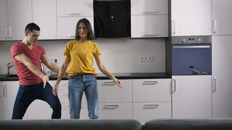 Couple dancing in the kitchen.