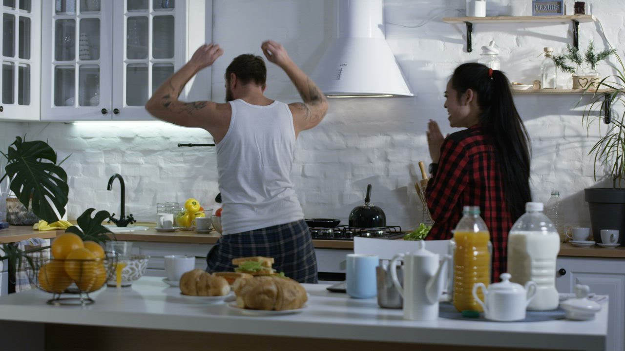 Couple dancing in the kitchen before breakfast Free Stock Video