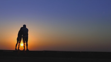 Couple enjoying a romantic sunset.
