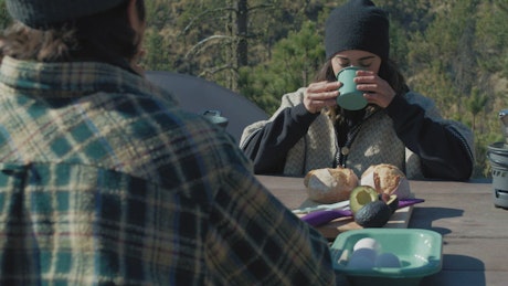 Couple having breakfast in a campsite