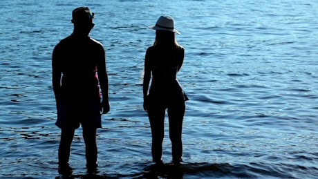 Couple holding hands at the lake.