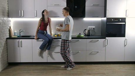Couple listening to music in the kitchen