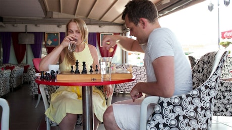 Couple playing a game in a cafe.