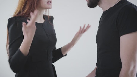 Couple quarrel with hand gestures on white background.