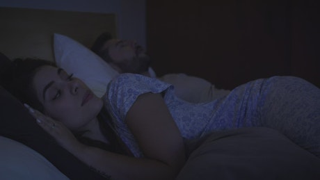 Couple sleeping together, angry at each other