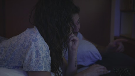 Couple surfing the internet together at night