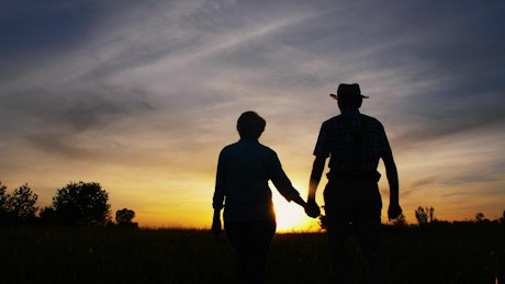 Couple walking at sunset.