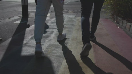 Couple walking in the street holding hands.