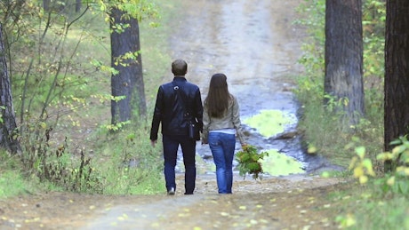 Couple walking in the woods.