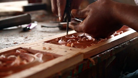 Craftsman carving wood.