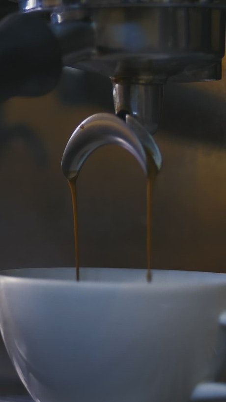 Cup being filled with coffee in a coffee machine