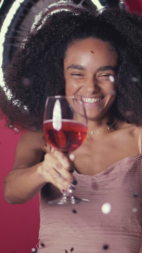 Curly haired young woman toasting on Valentine's Day.