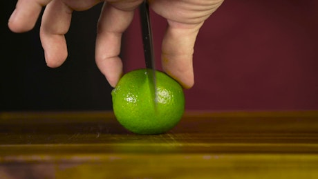 Cutting a lime in half for drinks