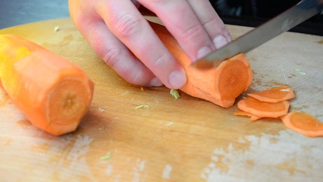 Cutting carrot slices when cooking.